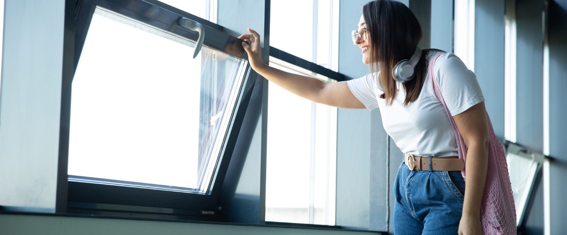 mujer mirando desde Ventanas de aluminio en Barcelona